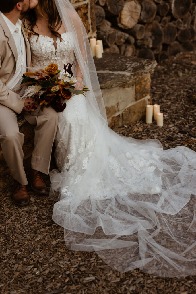 bridal detail photo of boho flowers and gown