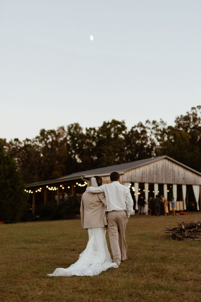 couple in sweet embrace during outdoor boho wedding